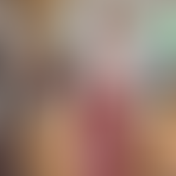 A picture of my dad, a tall slim bald man, wearing a light pink Moomin t-shirt and a long red and white striped apron.