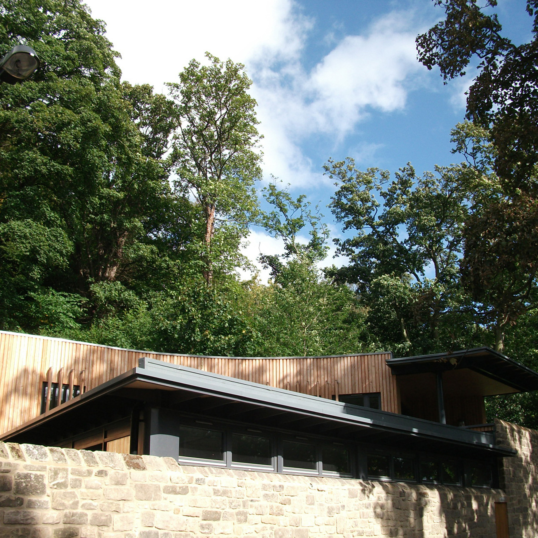 Mosedale Gillatt Architects Ltd — Millfield House Visitors Centre with blue skies looking over the main wall