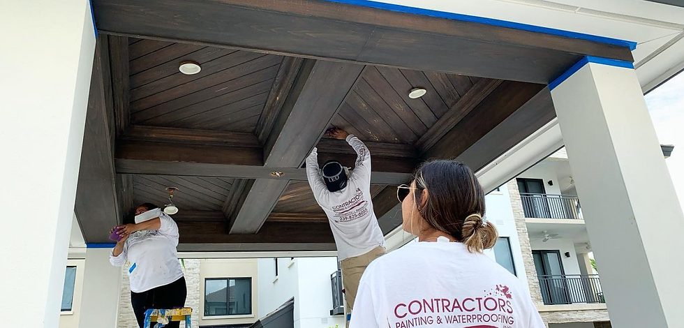 3 Contractor's painting workers working on a Gazebo ceiling ourdoors