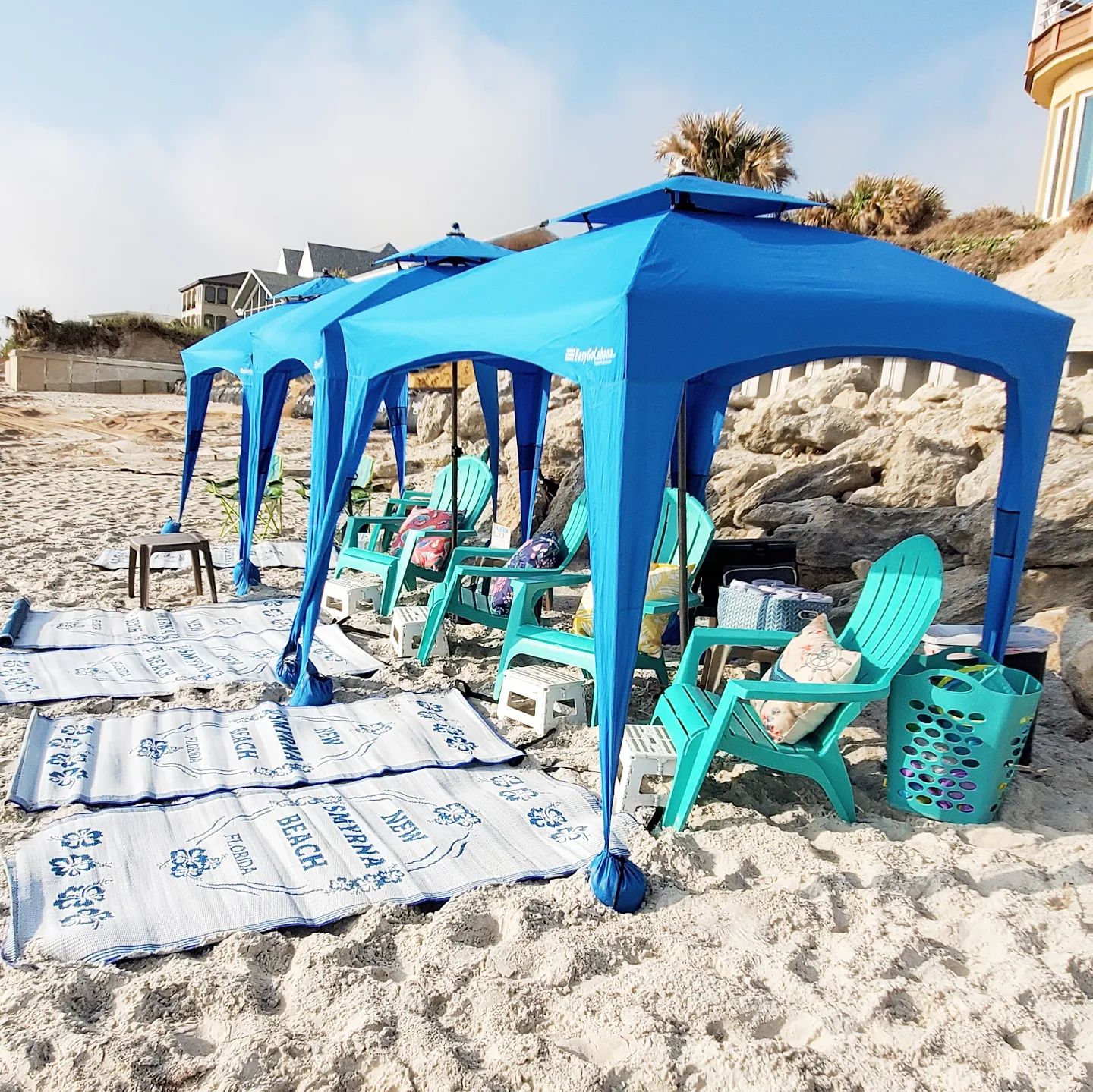 Beautiful beach set up with chairs, cabanas, and all the details.