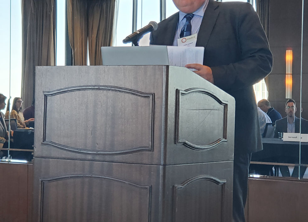 A man behind a podium giving a presentation.