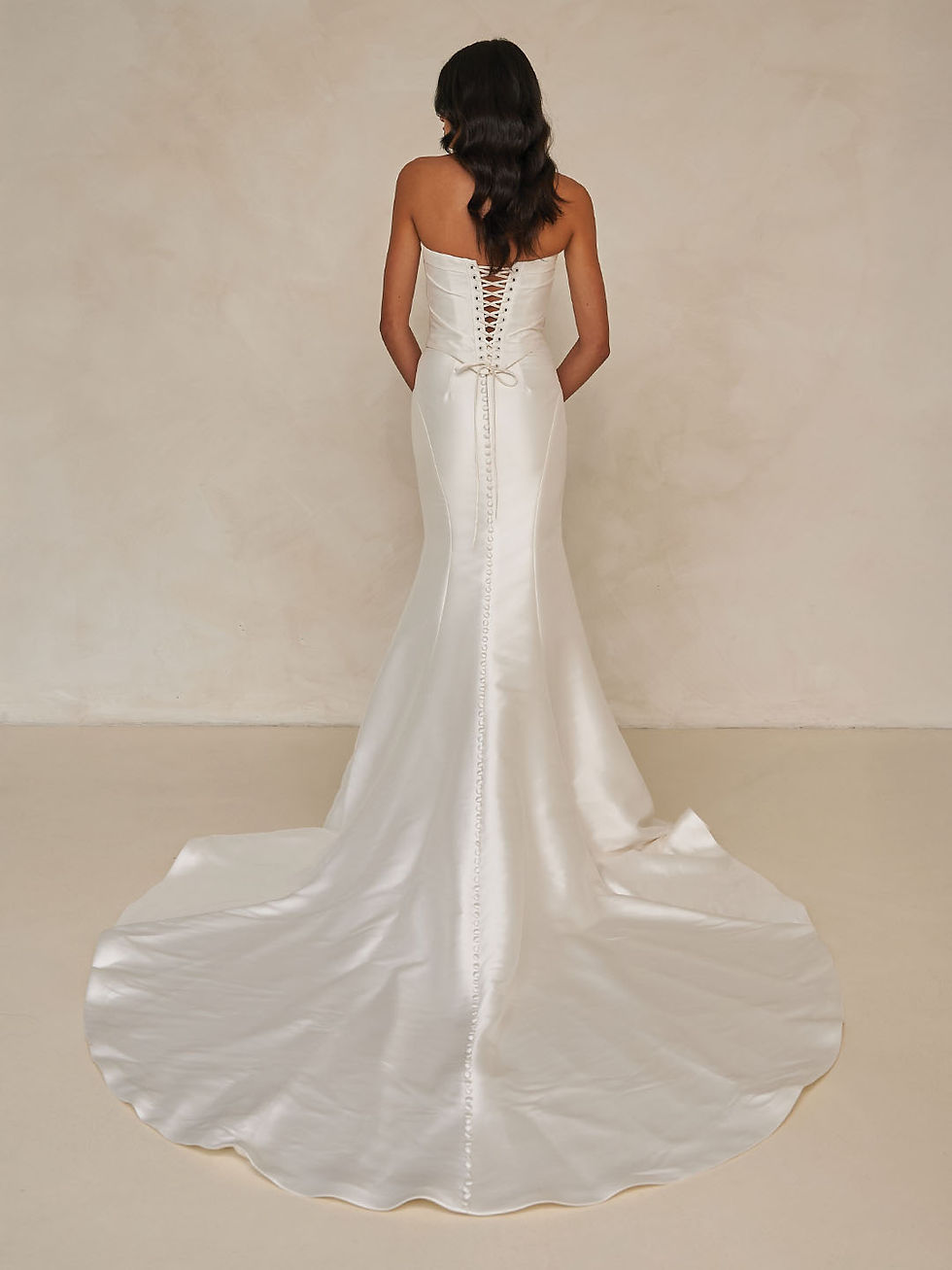 Thumbnail: Back view of Willis Skirt by Madi Lane satin bridal gown showcasing lace-up corset back and button-down detailing