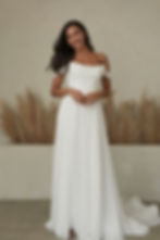 Bennet by Serene Madi Lane wedding dress showcasing its off-the-shoulder neckline, fitted bodice and elegant flowing skirt