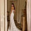 Thumbnail: Back view of Gleam by Milla Ova wedding gown with sleek lines and flowing train