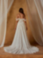 Nessa by Madi Lane bridal gown, featuring off-the-shoulder tulle sleeves, a structured corset back, and flowing A-line skirt