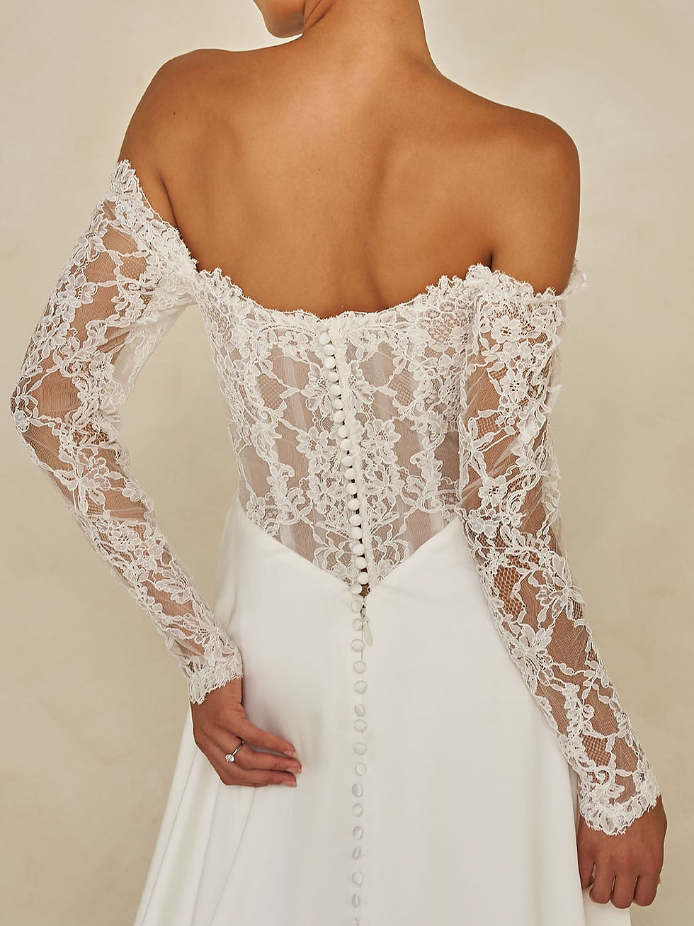 Thumbnail: Back close-up of the Ward by Madi Lane off-the-shoulder neckline and lace sleeves with ruched satin bodice.