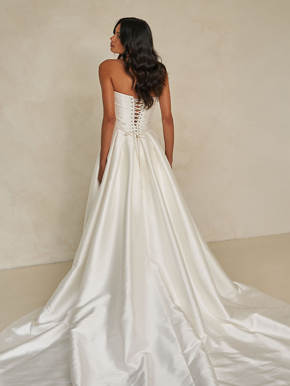 Thumbnail: Elegant strapless satin wedding dress with structured bodice and dramatic full overskirt – Wagner Overskirt bridal gown