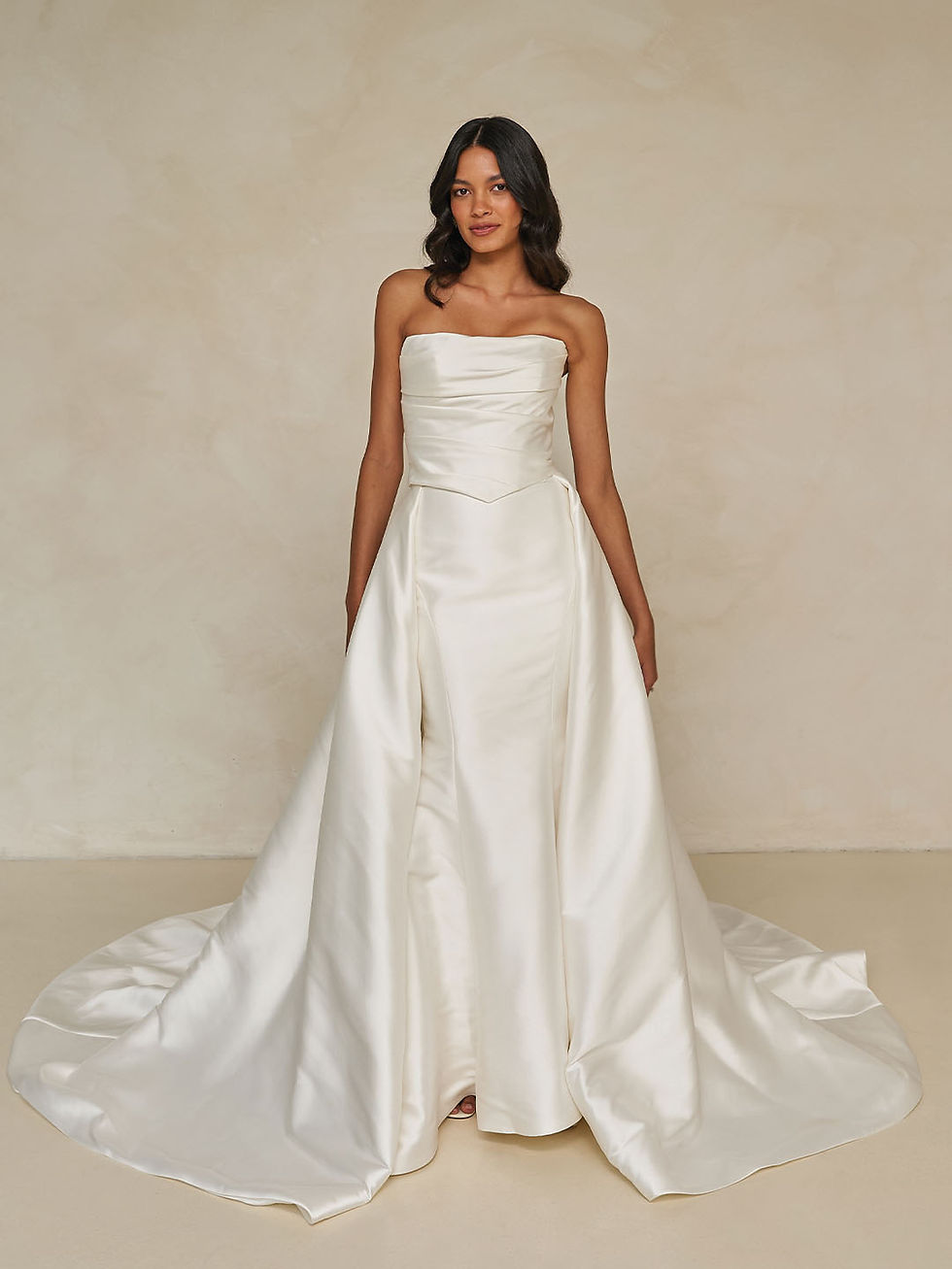 Thumbnail: Bride in Winston Bodice by Madi Lane styled with full satin overskirt and soft train for a timeless bridal look.