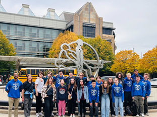 A group photo of members in Chicken Bot Pie in front of the Medtronic building in Fridley, MN. This photo was taken on the day of Jumpstart.