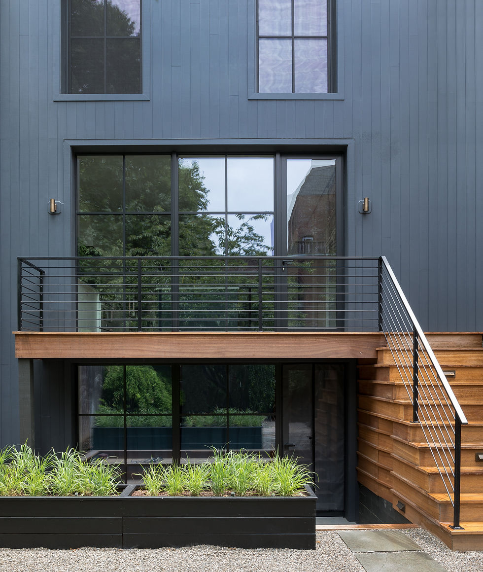 Modern steel railings complement the new steel windows on the back wall, which continue down to the garden level (that space was converted into a separate apartment for the homeowners’ parents or a future rental). The architects used Boral’s Truexterior vertical siding with a nickel gap joint for the exterior cladding and mahogany wood for the new deck.