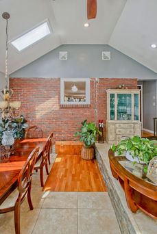 In the back 3 season room, there's an exposed brick wall. 
