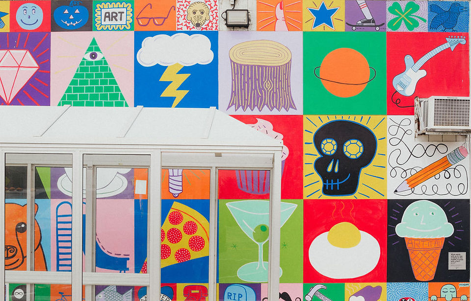 A wide angle shot of the mural that has bright squares and icons in colored blocks