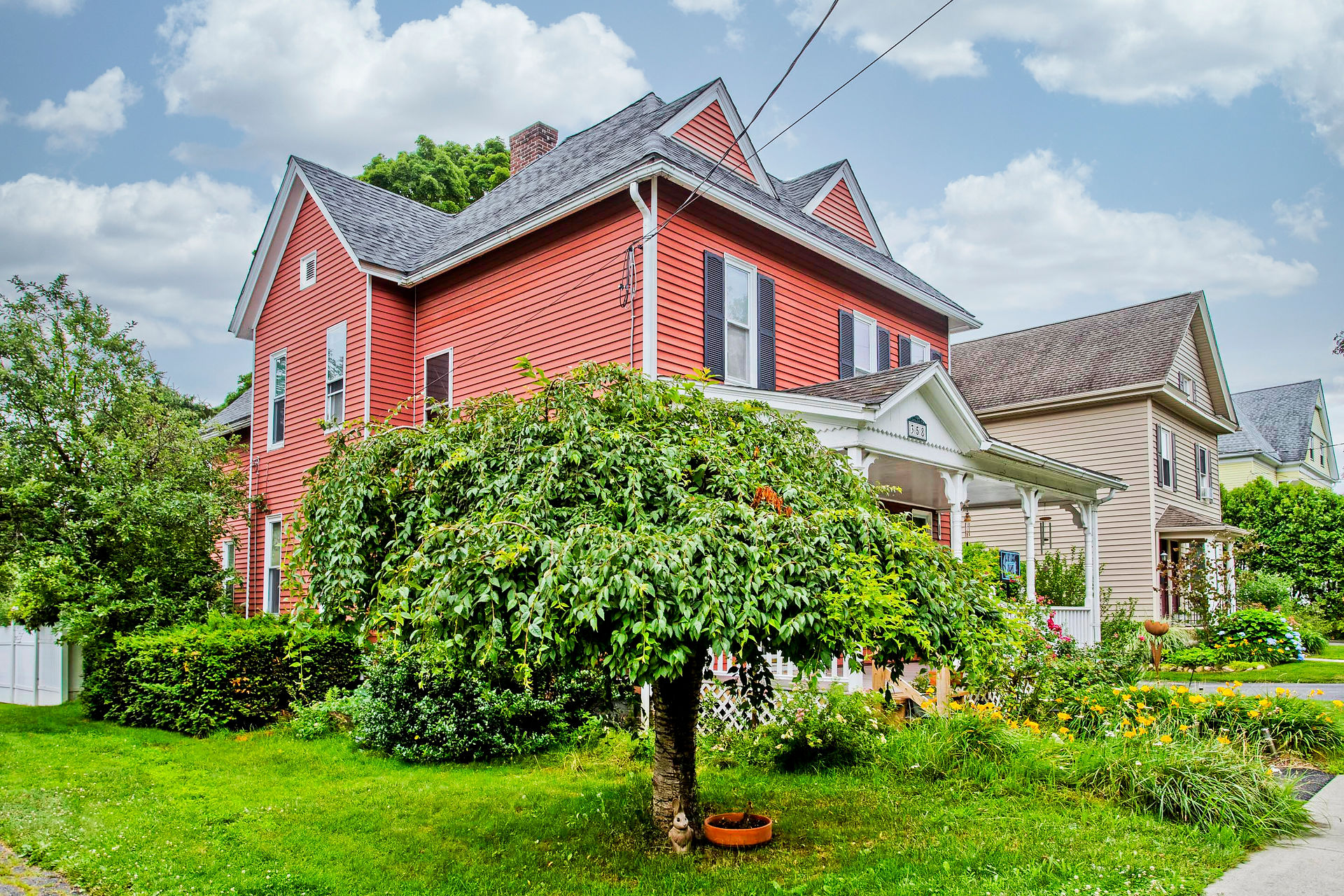358 Pleasant St, Holyoke MA 01040, located near Northampton MA. This is a corner shot of the property. It has a newer roof and several pitches that add details to its outline. 