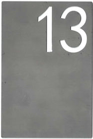 A steel table number label for a wedding with the number "13" cut out of it.