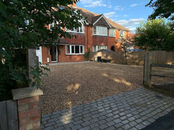 Driveway entrance in brick and gravel