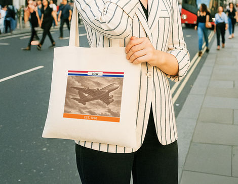 Close-up of Totemikaa Vespucci Duo LHR tote bag held against an urban street background.