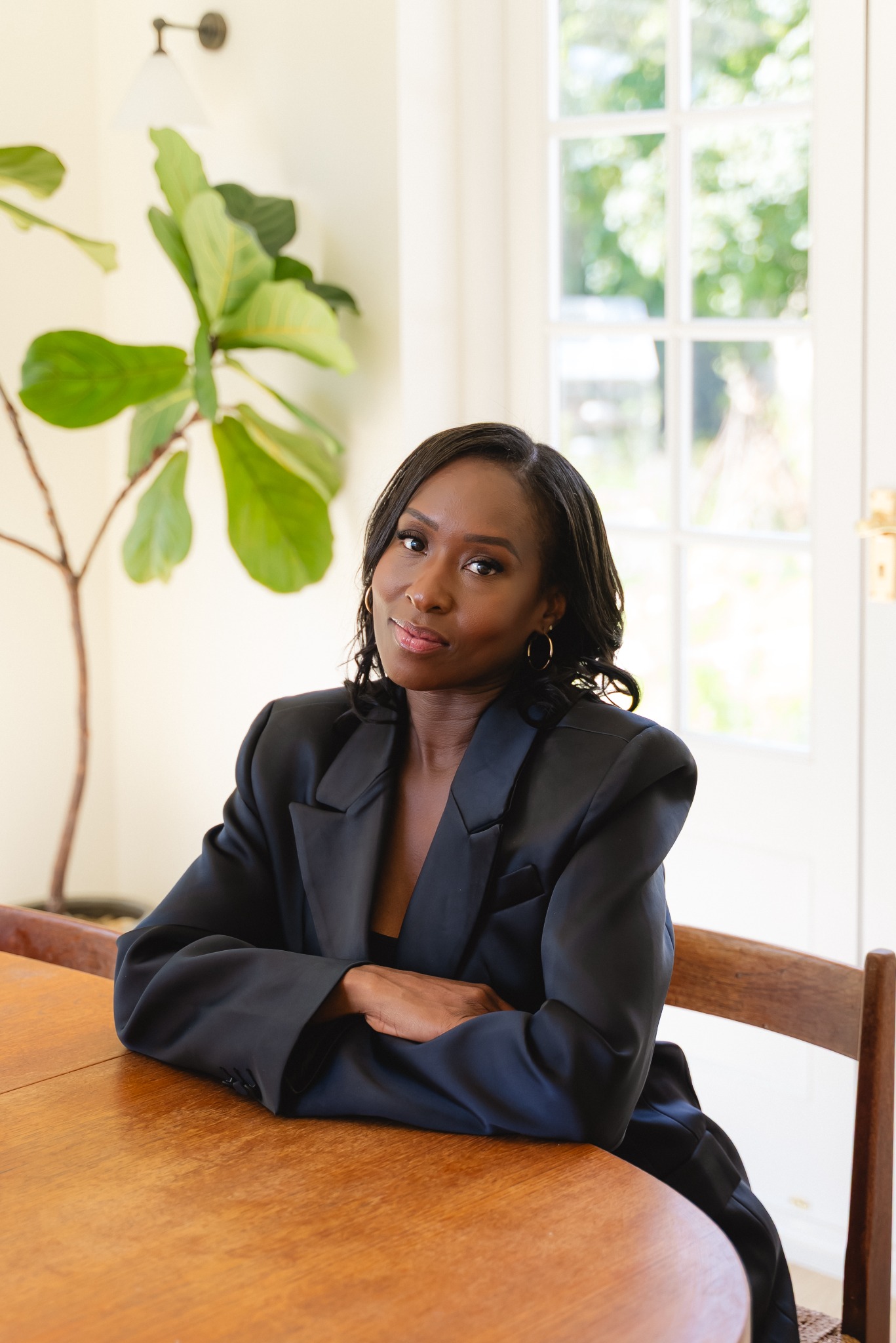 Danielle Reid at a table wearing a black blazer