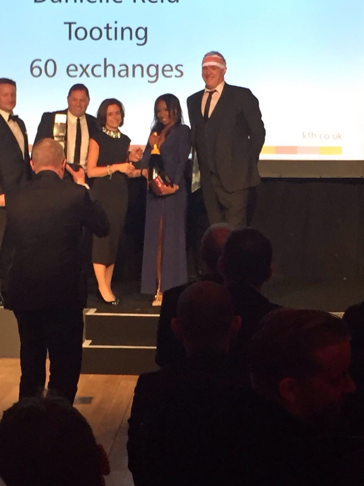 Danielle Reid receiving recognition at a previous agency awards event