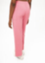 Thumbnail: Woman in Cutxie Club Scrub Pants in colour pink with features of toggle, elastic waistband, pockets, pleat, straight fit
