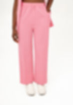 Thumbnail: Woman in Cutxie Club Scrub Pants in colour pink with features of toggle, elastic waistband, pockets, pleat, straight fit