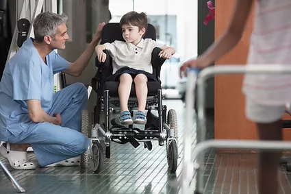 Doctor Talking to Boy in Wheelchair.webp