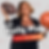 Joy Taylor poses with a football in one hand and a basketball in another. With branding of her podcast overlaying the image