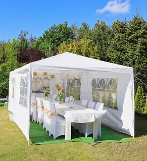 Garden tent for a communion party with a table and white decorations.jpg