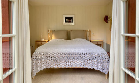 Sovrum med dubbelsäng och ljusa väggar – sovrumsrenovering fritidshus