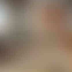 A colorful kilim carpet with geometric patterns in a Scandinavian-style living room with minimalist furniture.