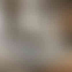 A modern living room featuring a bespoke carpet designed to fit perfectly within the room's layout, with a unique shape that complements the furniture arrangement and natural light.