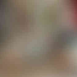 A sophisticated living room featuring a bespoke carpet with vibrant custom borders and edges, enhancing its overall appearance with a polished, tailored finish, complemented by colorful furniture and natural light.