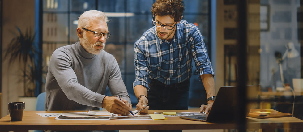 Small business professionals strategizing over visual materials, demonstrating collaborative planning and design for mission-driven growth.