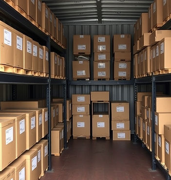 racked storage with labelled boxes. Industrial shelving inside a 20ft outdoor storage container