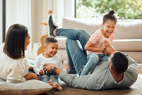 Happy family hanging out in their Mechanicsburg, PA home after daflure heating cooling and solar installed their new AC unit