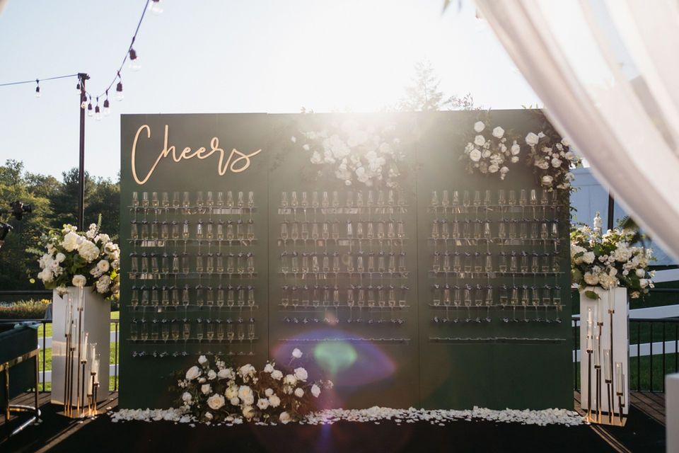 Custom Champagne wall with flowers and lighting at a wedding reception in Central PA