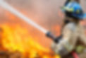 Susquehanna Township Firefighter from Progress Fire Company Spraying Water at a Field on Fire
