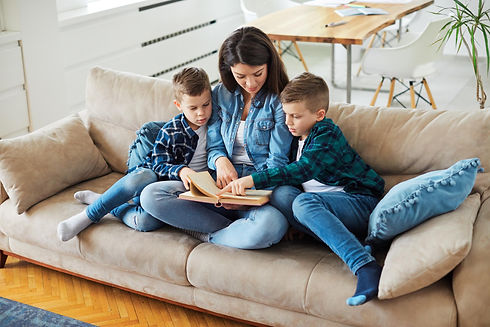Mother and her sons reading a book in their Marysville PA home that was recently serviced by DAflure heating cooling and solar