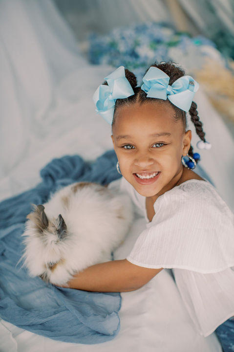 A beautiful little girl with a fluffy bunny during Jessica Snider's Photography holiday Easter sessions at her Mechanicsburg, PA photography studio