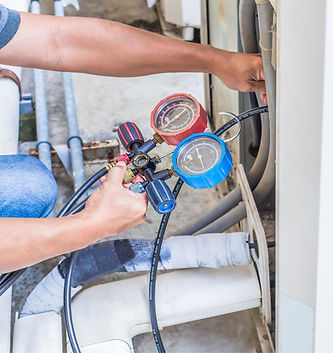A Daflure HVAC service technician in Camp Hill, PA checking the numbers on a heating and air conditioning unit