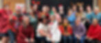 A silly group shot of Cadence with everyone in holiday attire including reindeer headbands, santa hats, and cheerful sweaters