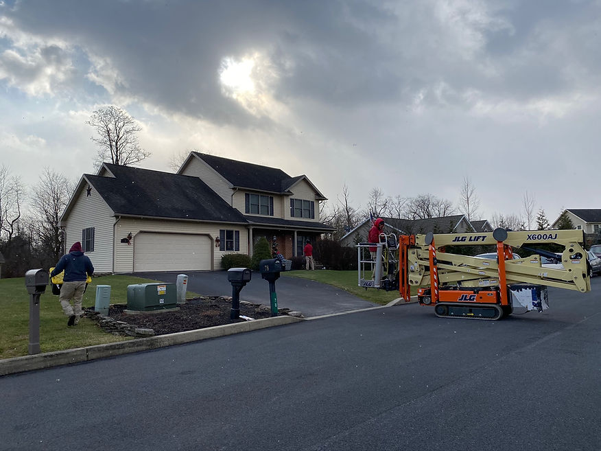 Team at Christmas Decor of Harrisburg working on a Christmas Light Install for Central PA home