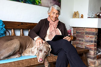 A woman searching Central PA air quality and air humidifiers with her dog on a bench in her Wormleysburg, PA home