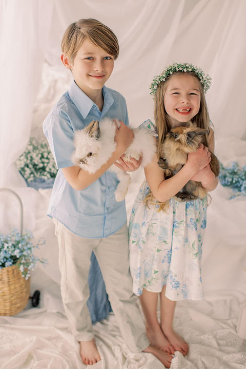 Siblings holding bunnies during a springtime family photo session with Jessica Snider Photography at her Mechancisburg, PA farmette photo studio