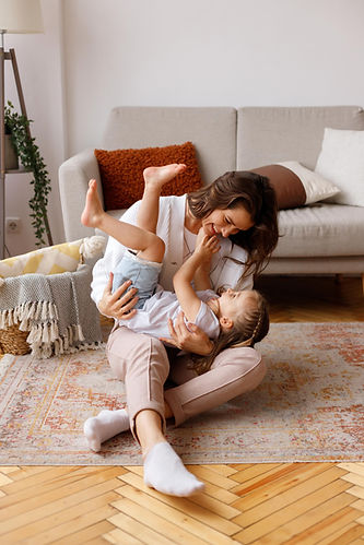 Mother and daughter playing in their living room after Daflure service their AC unit in Harrisburg PA