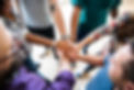 people of different color, genders, body shapes, religions, political beliefs, and backgrounds holding their hands together in a circle