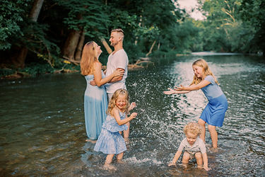 Family photo in Mechanicsburg, PA featuring children splashing in the river