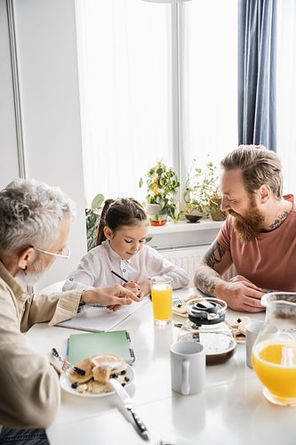 A family eating breakfast in Hershey, PA after Daflure Heating and Cooling finished installing a new radiant heat floor system