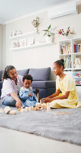 Mother, daughter, and grand daughter playing on the floor of a cooler room in their home a