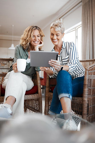 Friends planning a trip on a computer after having Daflure Heating Cooling and Solar Manage their air conditioning installation in Hershey PA