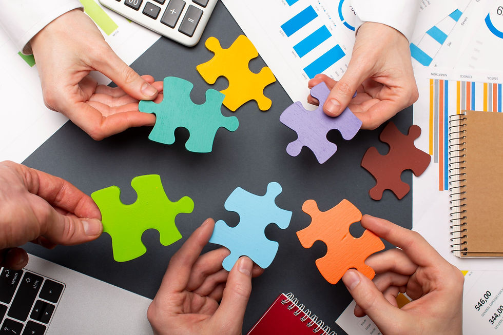 Colorful puzzle pieces over an office desk showcasing the different pieces of marketing that go together
